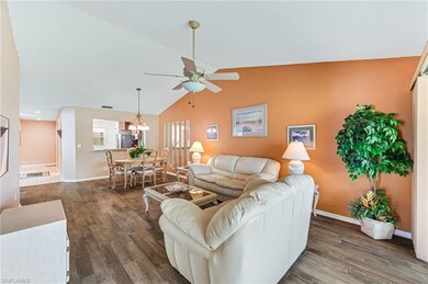 Living room featuring lofted ceiling, visible vent