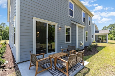Back of house featuring a sunroom and a yard