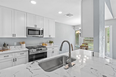 Kitchen featuring stainless steel appliances, whi