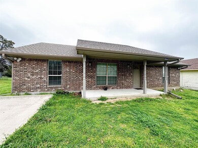 Single story home featuring a front yard and a patio