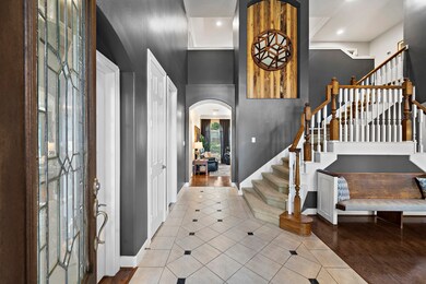 Upon entering the home, you walk into this spacious entryway that leads straight into the living room. To the left you'll find a private office with glass French doors and to the right you'll find a large dining room that leads to the kitchen.