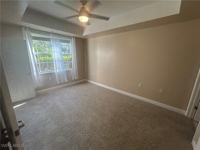 Spare room featuring a raised ceiling, a ceiling f