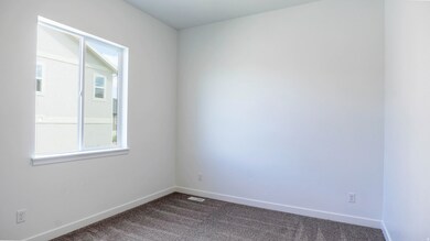 Unfurnished room featuring dark colored carpet and baseboards