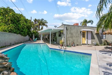 Summer party time awaits...your own staycation paradise with large pool, BBQ area, covered entertainer's patio and palm trees.