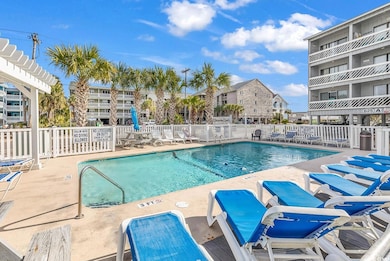 Pool with a patio and fence
