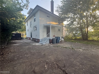 View of front of home featuring a chimney and driveway