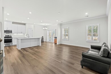 Living room featuring sink, an inviting chandelier