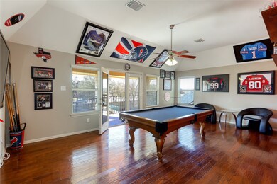 Game Room with custom wood floors and plenty of room to play pool without bumping into walls.  French doors lead to the 2nd floor balcony with room for a table and chairs to relax while looking over the entire back yard.