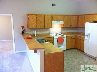 Kitchen bar accommodates four bar stools easily.  