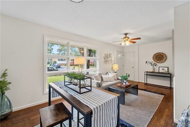 Living room with hardwood floors and ceiling fan