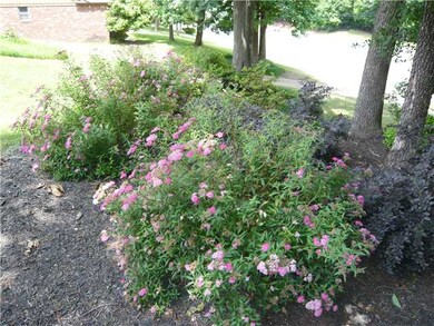 Flowers and trees provide privacy sheild in front 