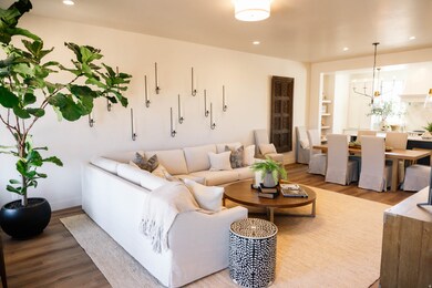 Living area with wood finished floors, recessed lighting, and a chandelier