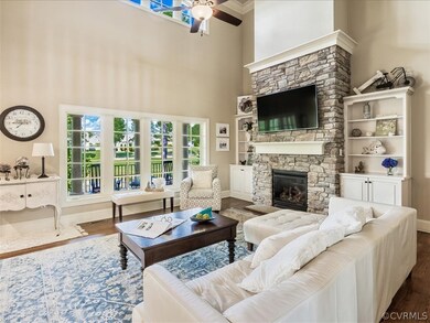 Two story family room with stone (gas) fireplace.