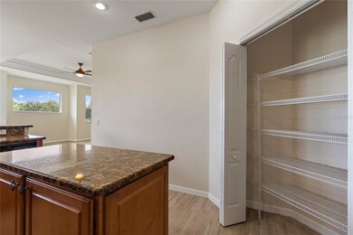 Island with slab granite countertops and a pantry 