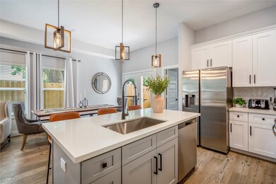 The chefs kitchen features an abundance of cabinetry.