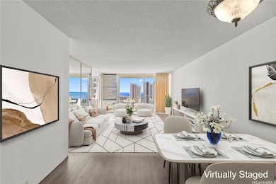 This enhanced, virtually staged image shows how the spacious living room can be comfortably furnished while highlighting the ocean and city backdrop.