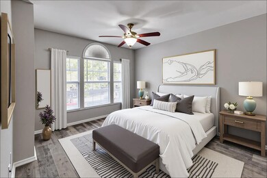 Bedroom with wood finished floors and ceiling fan