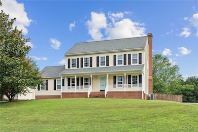 Colonial home with a chimney, a porch, and roof wi
