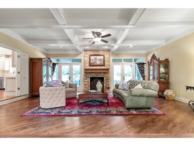 Spacious living room with stone fireplace looks ou