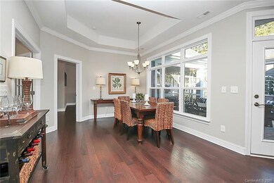 Dining room with windows overlooking patio and wat