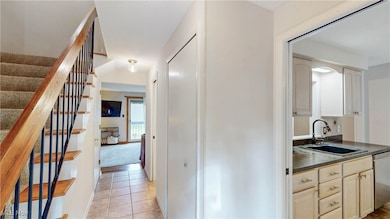 View from front door down hallway to LR, w/coat closet, and half-bath on right w/pocket door