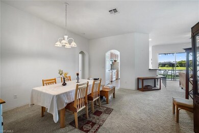 Carpeted dining room featuring an inviting chandel