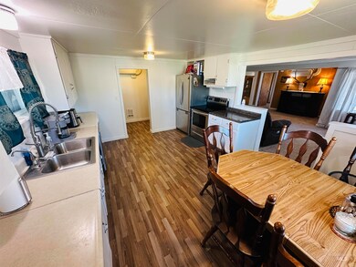 Dining space with baseboards and dark wood-style floors