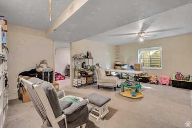 Living room with light carpet and a ceiling fan