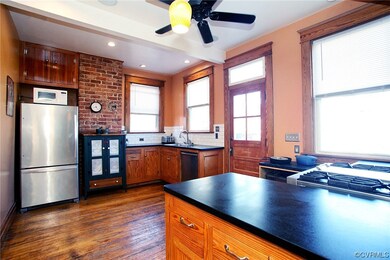 Hardwoods, exposed brick, custom Fir cabinets, Brazilian Soapstone countertops