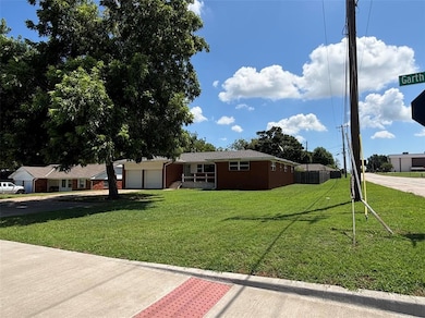 View of front of property with an attached garage, a front yard, concrete driveway, and brick siding