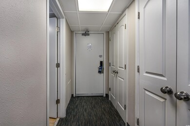 Corridor featuring a paneled ceiling