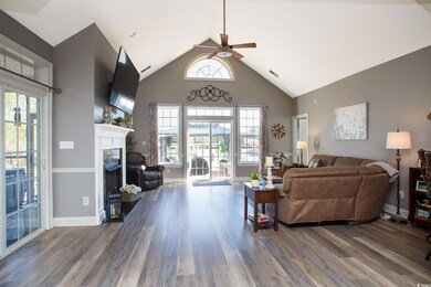 Living room with ceiling fan, wood-type flooring, 