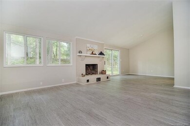 Spacious living room kissed with fresh paint and natural light through the new windows.