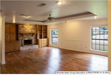 Huge living room with fireplace, tray ceiling and 