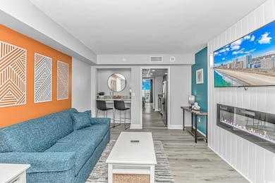 Living room with baseboards, visible vents, and wo