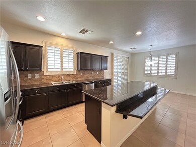 Kitchen with stainless steel appliances, visible v