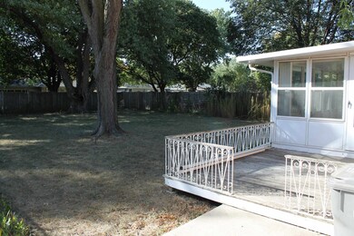 Large backyard features deck and 3 seasons room ac