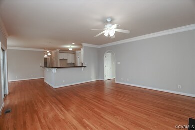 Unfurnished living room with ceiling fan, light ha