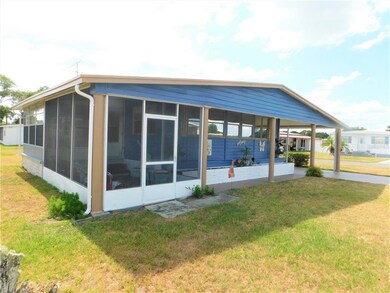 Screen room patio area in front of home.