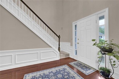 Entrance foyer featuring wainscoting, a decorative