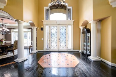 Foyer featuring a high ceiling, an inviting chande