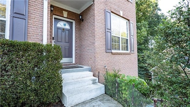 View of exterior entry with brick siding