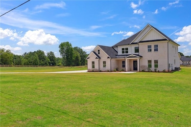 View of front of property featuring a front lawn, brick siding, a standing seam roof, and a metal roof