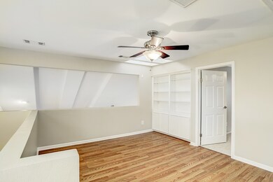 Upstairs loft. 3rd bedroom is to the right. Lamina