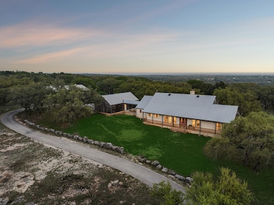 Birds eye view of property featuring a wooded view
