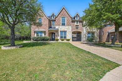 View of front of home featuring a front lawn, a ga