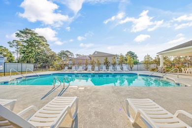 Community pool with a patio