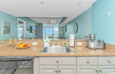 Kitchen featuring sink, dishwasher, a textured cei