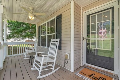 Wooden porch featuring ceiling fan