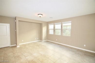 Spare room featuring baseboards